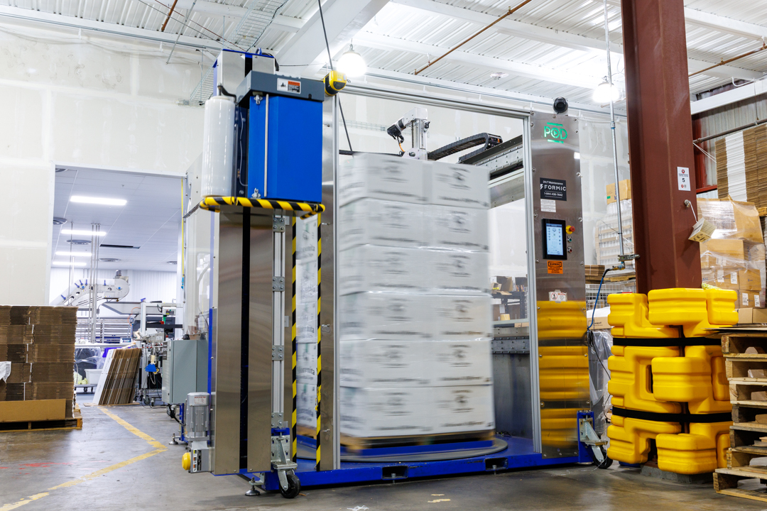 Formic automated pallet wrapper finishing a stack of cases, consistent throughput, hands-off changeovers